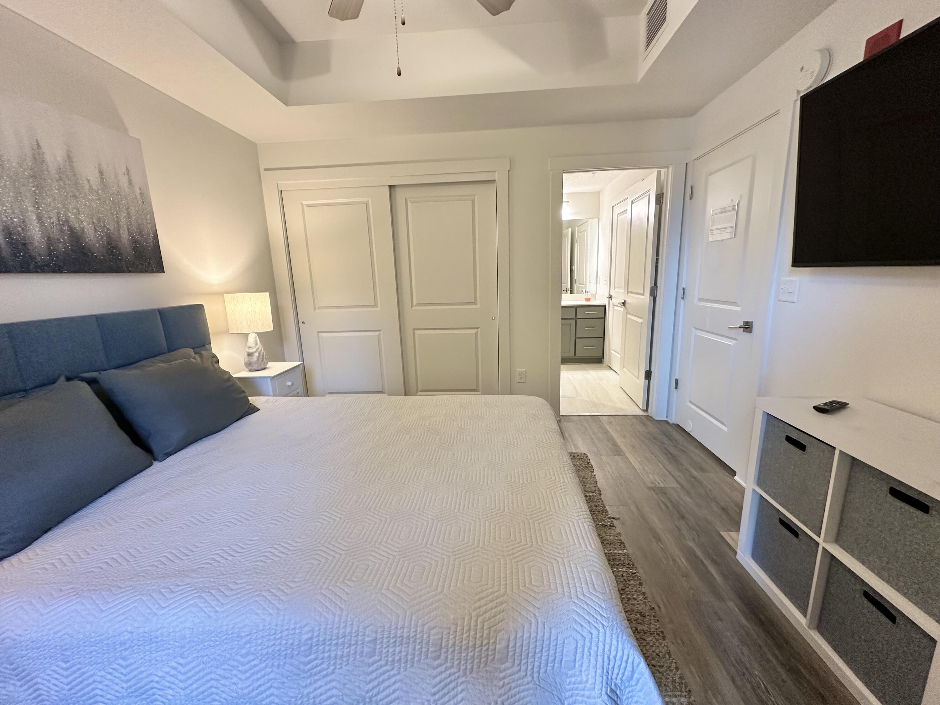 15928 Front Beach Road, Unit 3702 Panama City Beach, FL 32413 - Photo 38 of 85 a bedroom with a bed and a flat screen tv