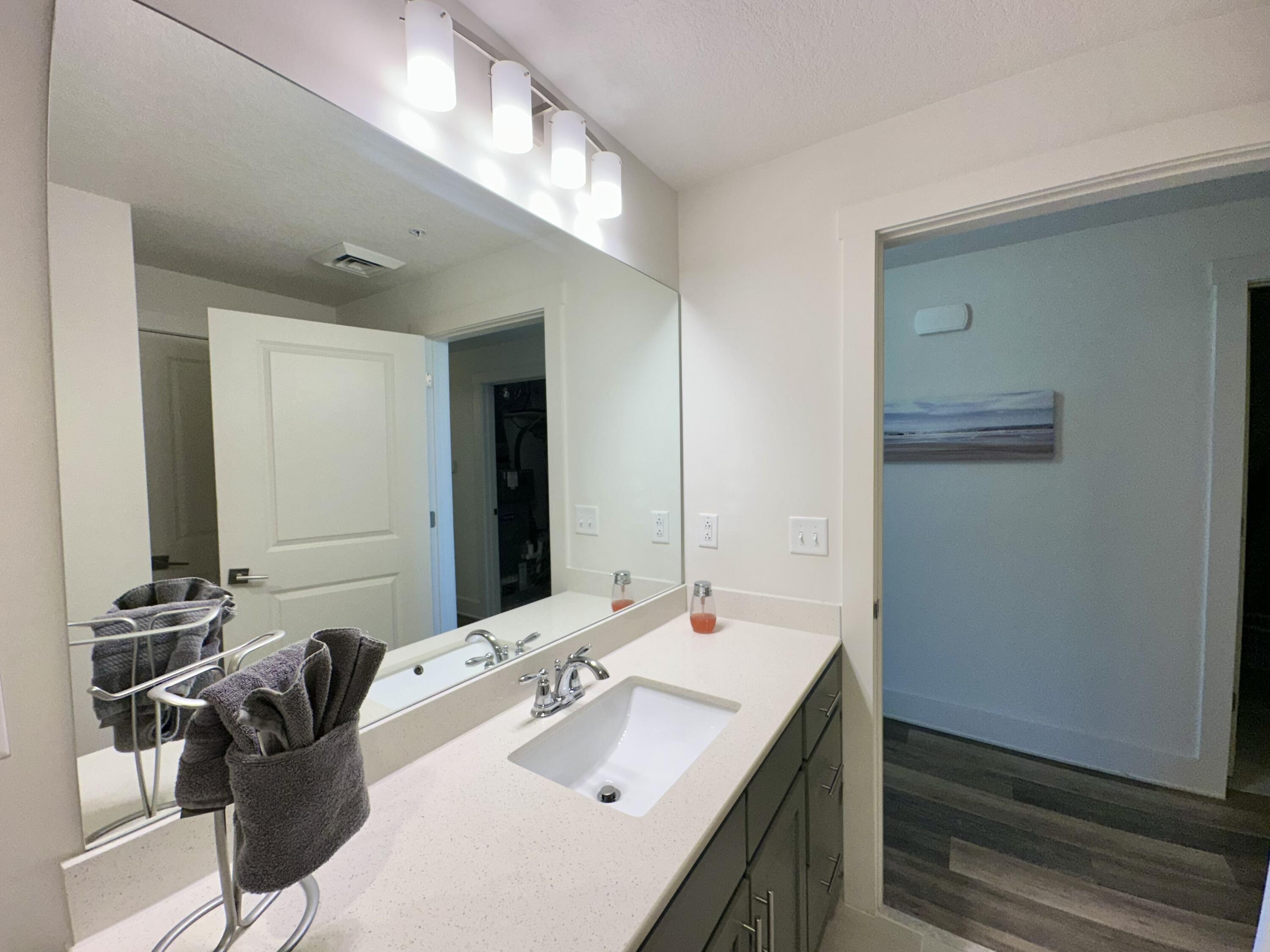 15928 Front Beach Road, Unit 3702 Panama City Beach, FL 32413 - Photo 41 of 85 a en suite bathroom with a sink and a mirror