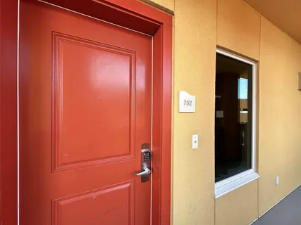 a living room with furniture gym equipment and a floor to ceiling window