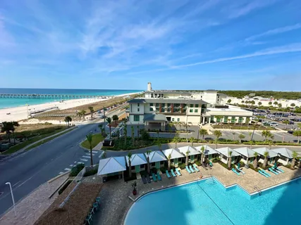 a kitchen with a sink dishwasher stove and white cabinets with wooden floor