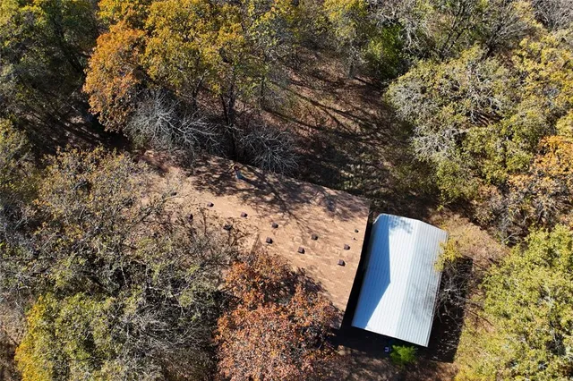 a aerial view of a house with a yard and covered with swimming pool