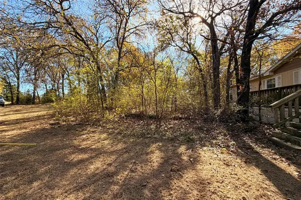 a view of balcony with wooden floor and fence