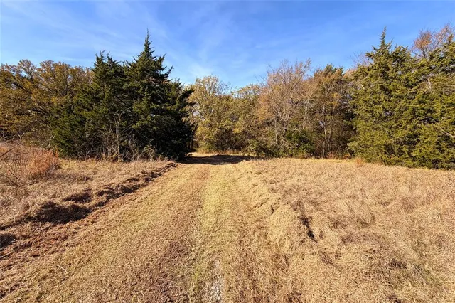 a view of snow covered with snow in middle of the road