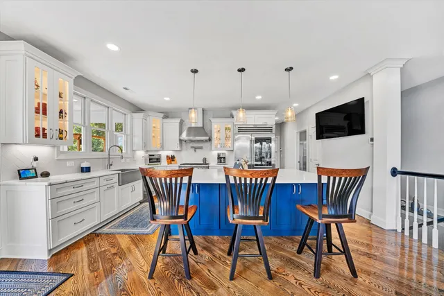 a living room with stainless steel appliances furniture and a table