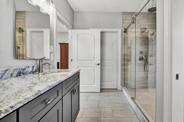 a view of a balcony with chairs and wooden floor