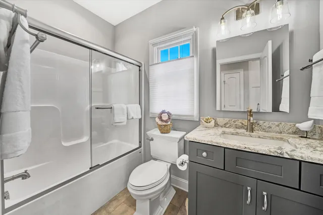 a view of a balcony with wooden floor next to a yard