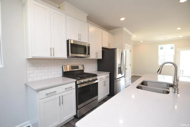 a kitchen with a sink white stove and refrigerator