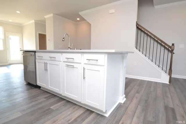 a view of a hallway with granite countertop wooden floor and entryway