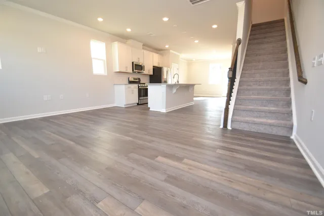 a view of kitchen with wooden floor and electronic appliances