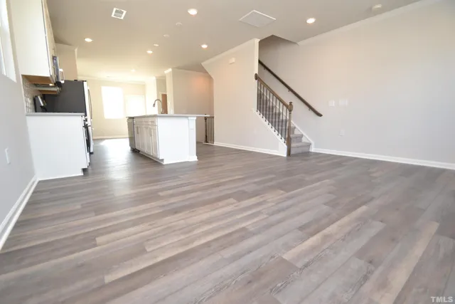 a view of a kitchen with wooden floor and stairs