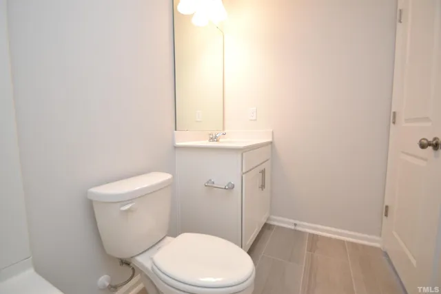 a white toilet sitting next to a bathroom sink