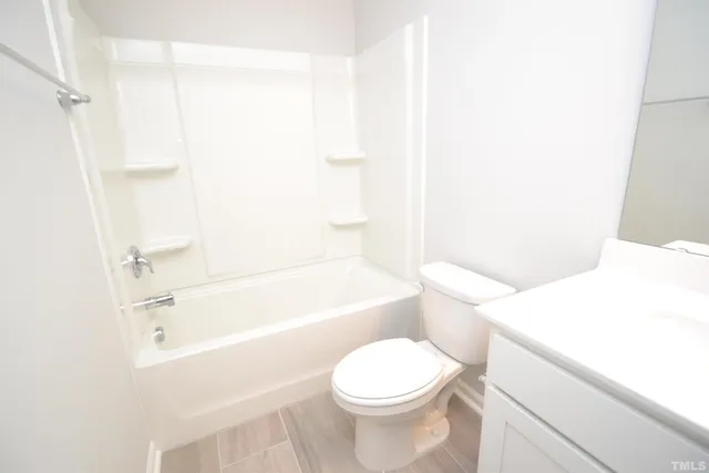a bathroom with a sink a toilet and bathtub