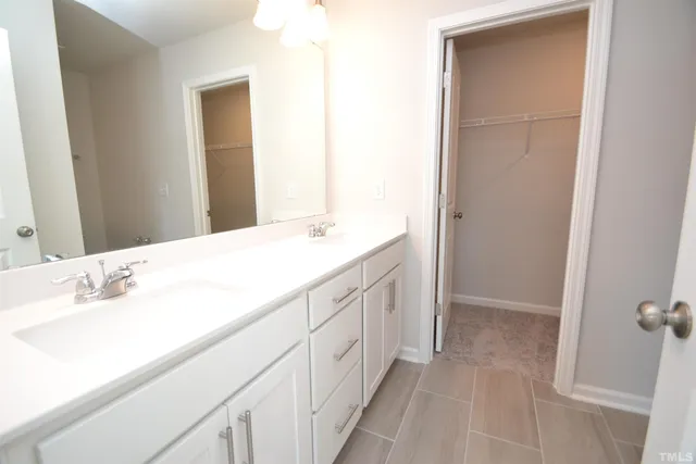 a spacious bathroom with a sink and a mirror