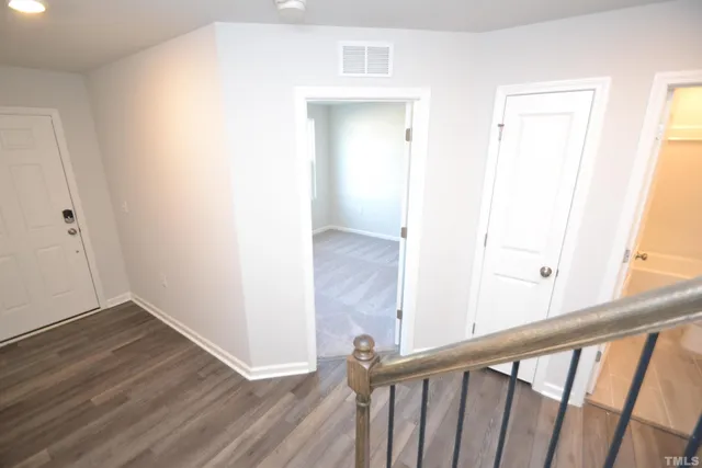 a view of a hallway with wooden floor