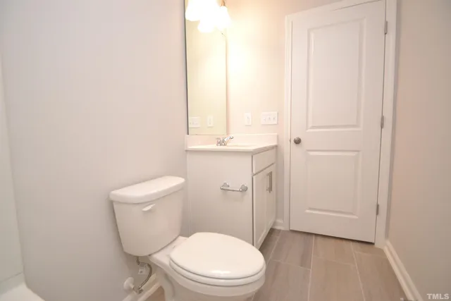 a white toilet sitting next to a bathroom sink