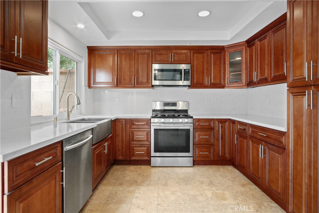 4 Brisa Irvine, CA 92620 - Photo 11 of 17 a kitchen with stainless steel appliances granite countertop a sink stove and microwave