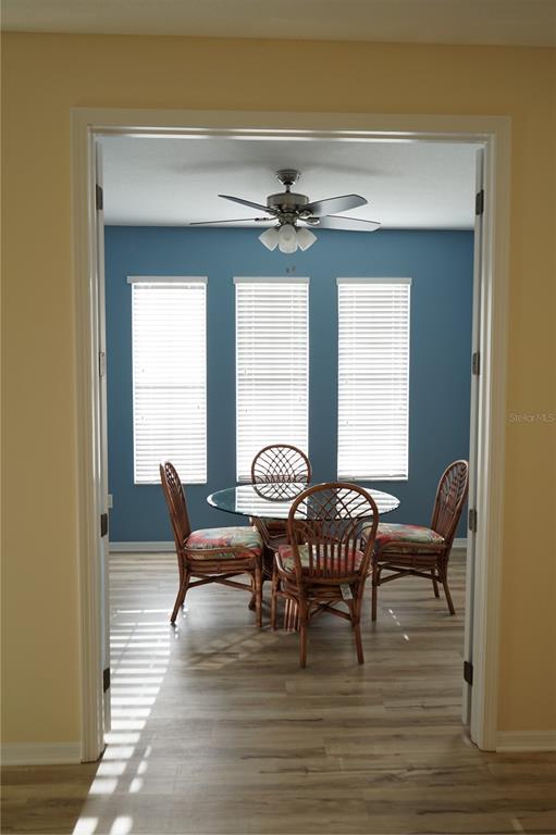 201 Sunset Crest Court Apollo Beach, FL 33572 - Photo 17 of 81 a dining room with furniture a chandelier and wooden floor