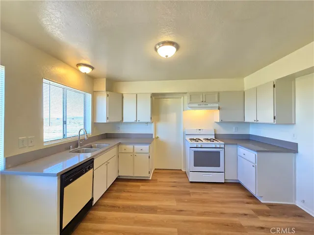 a kitchen with stainless steel appliances granite countertop a sink and stove