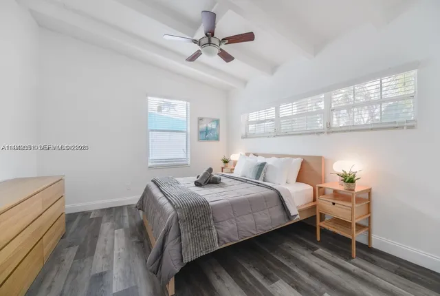 a bedroom with a bed and a ceiling fan