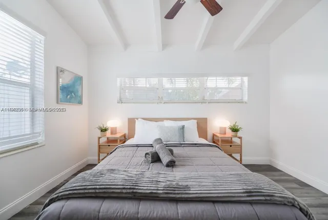 a bedroom with a bed and window