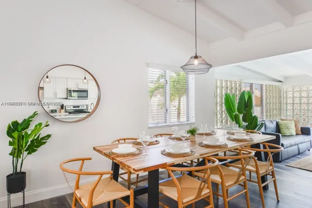 a dining room with furniture a window and a chandelier