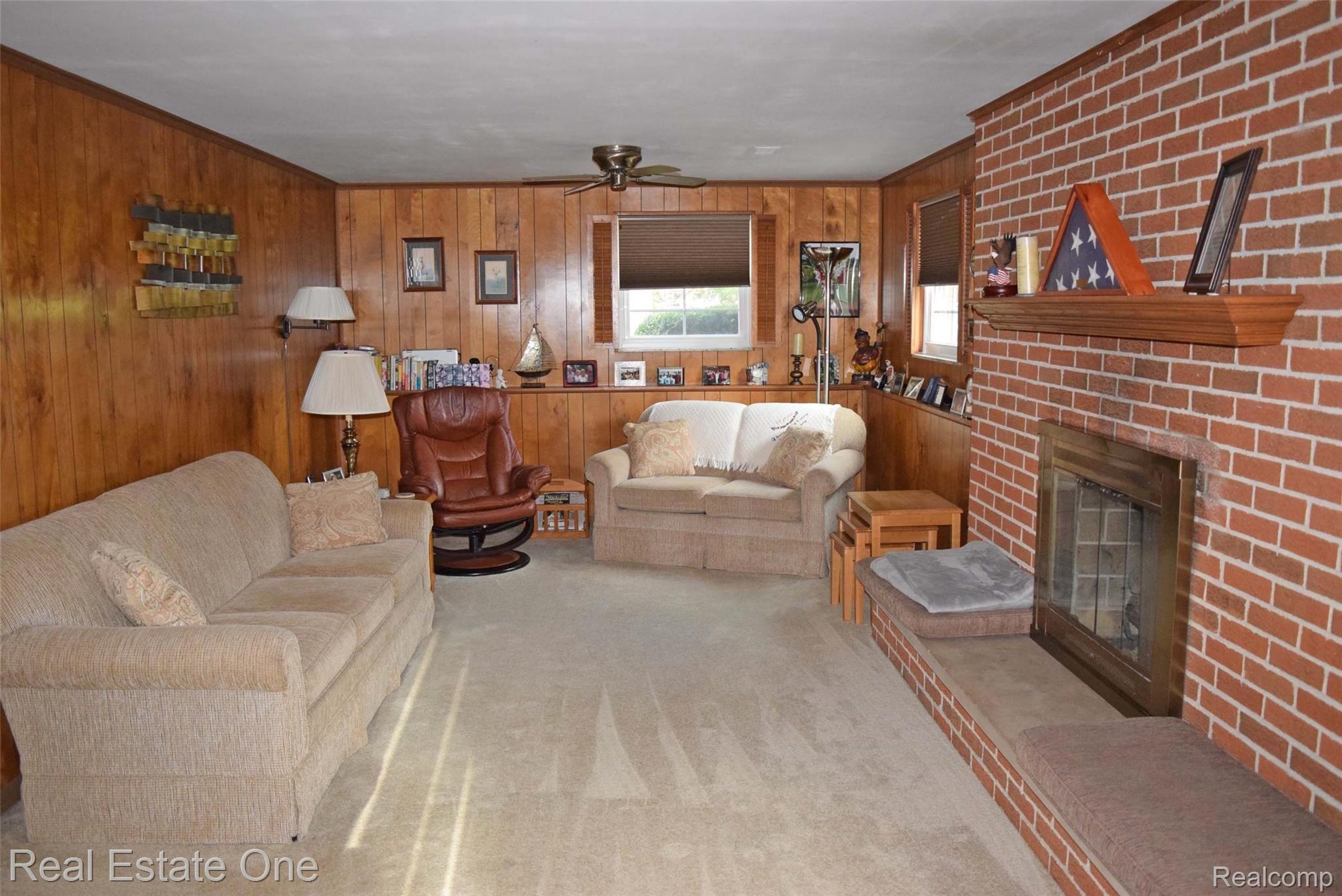 450 Taylor Road Brighton, MI 48114 - Photo 10 of 32 The lower level has a huge family room with fire place.