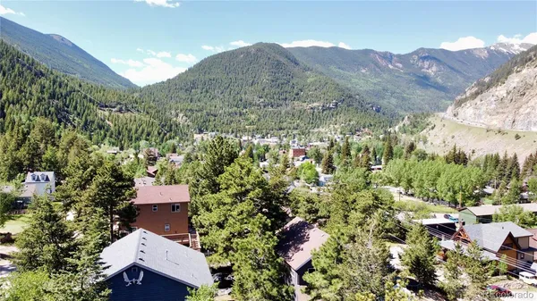 an aerial view of houses with a yard