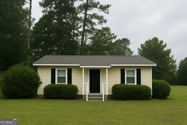 a front view of a house with a garden