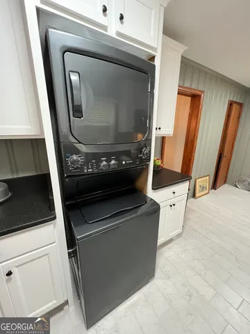 a view of a room with furniture and wooden floor