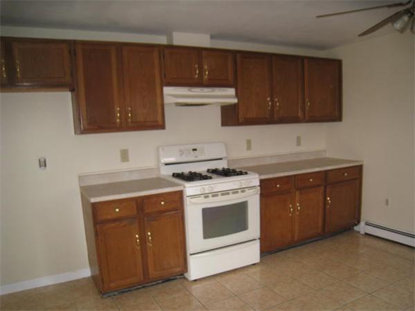 95 Bay Road, Unit A Revere, MA 02151 - Photo 5 of 12 a kitchen with sink a stove and cabinets