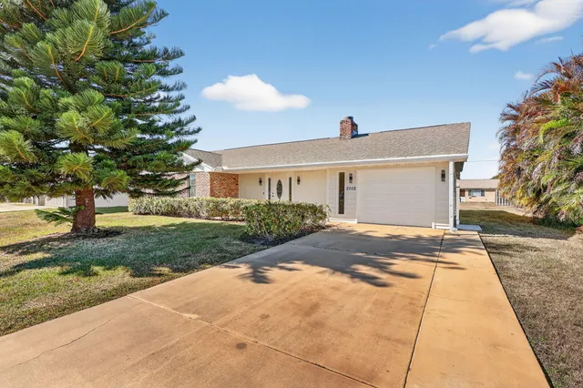 a front view of a house with a yard and a garage