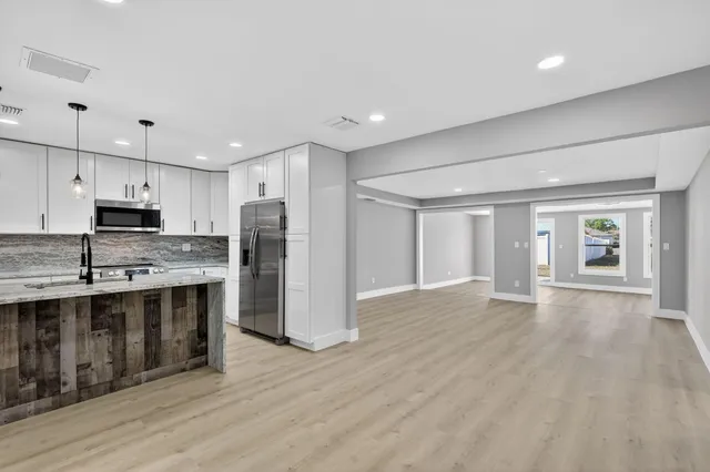 a view of a livingroom with wooden floor and window
