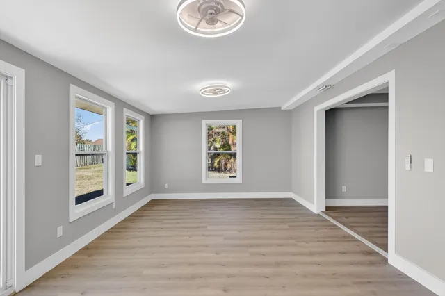 wooden floor in an empty room with a window