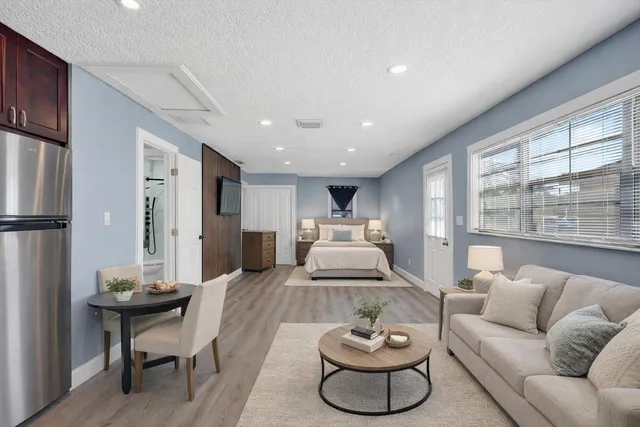 a kitchen with stainless steel appliances granite countertop a refrigerator and a sink