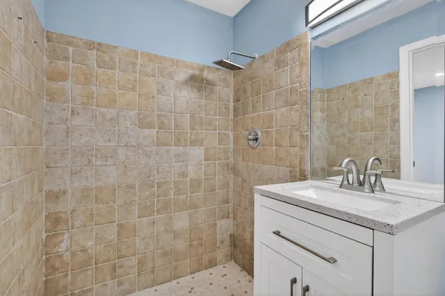 a bathroom with a sink a toilet and shower