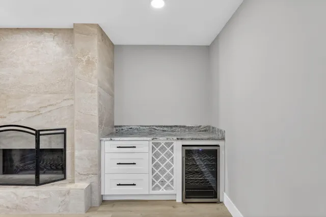 a view of kitchen with kitchen island microwave and cabinets