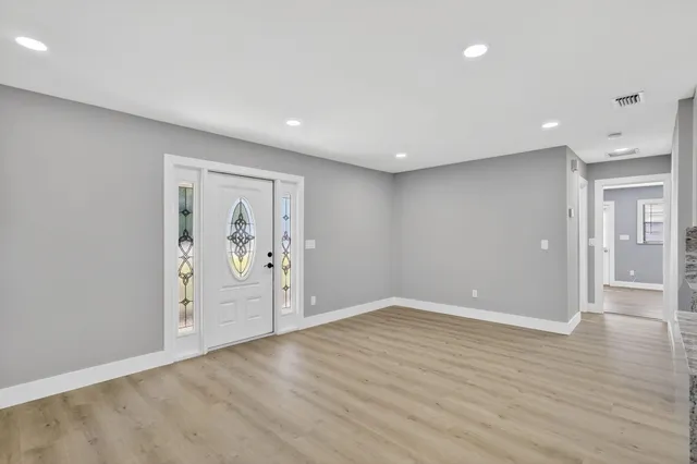 a kitchen with kitchen island stainless steel appliances a sink stove and refrigerator