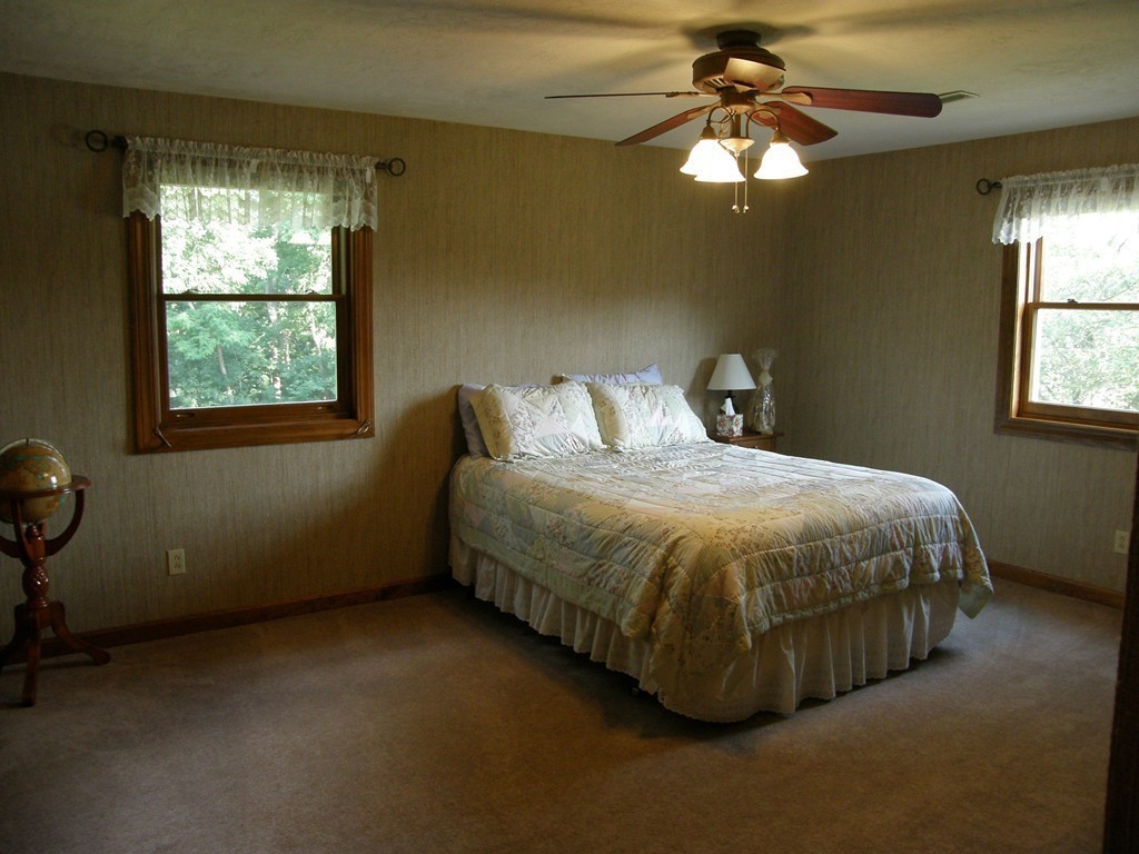 5 Corbin Road Dudley, MA 01571 - Photo 13 of 30 a bed sitting in a bedroom next to a window