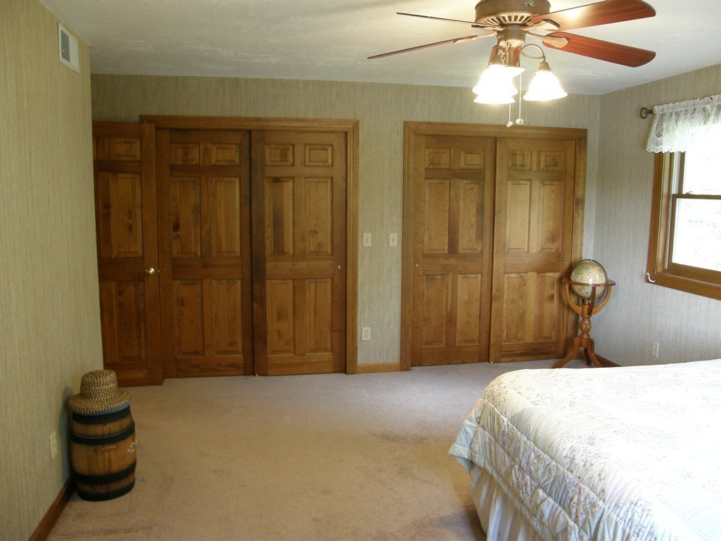 5 Corbin Road Dudley, MA 01571 - Photo 14 of 30 a bedroom with a bed and a chandelier