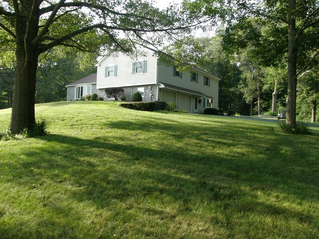 5 Corbin Road Dudley, MA 01571 - Photo 23 of 30 a front view of a house with a garden and trees
