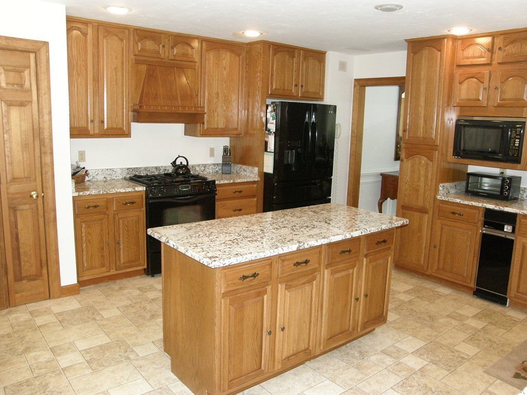 5 Corbin Road Dudley, MA 01571 - Photo 4 of 30 a kitchen with stainless steel appliances granite countertop a stove refrigerator sink and microwave