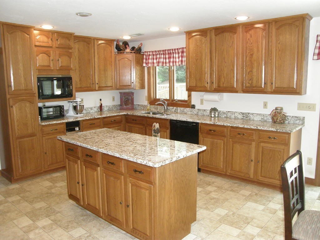 5 Corbin Road Dudley, MA 01571 - Photo 5 of 30 a kitchen with a sink stove and cabinets