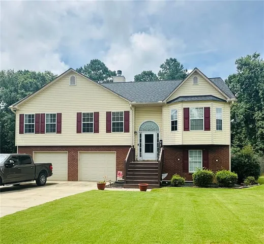 a front view of a house with a yard and garage