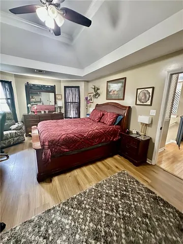 a bedroom with a large bed and a chandelier