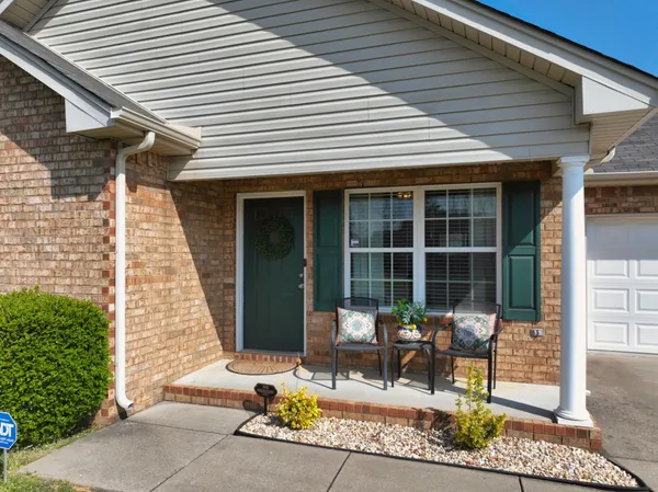 a view of a patio with table and chairs and potted plants