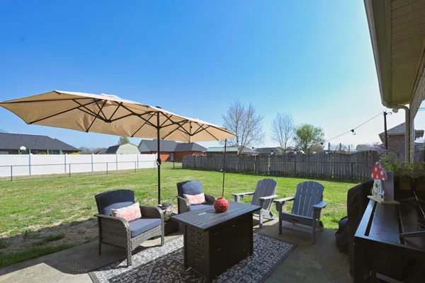 a couple of tables and chairs under an umbrella