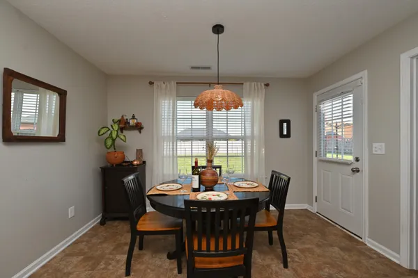 a dining room with a table and chairs