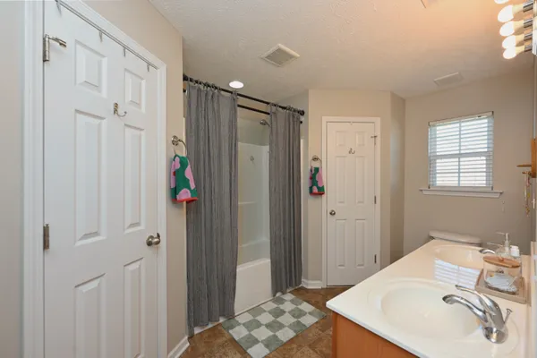 a bathroom with a sink a mirror and shower