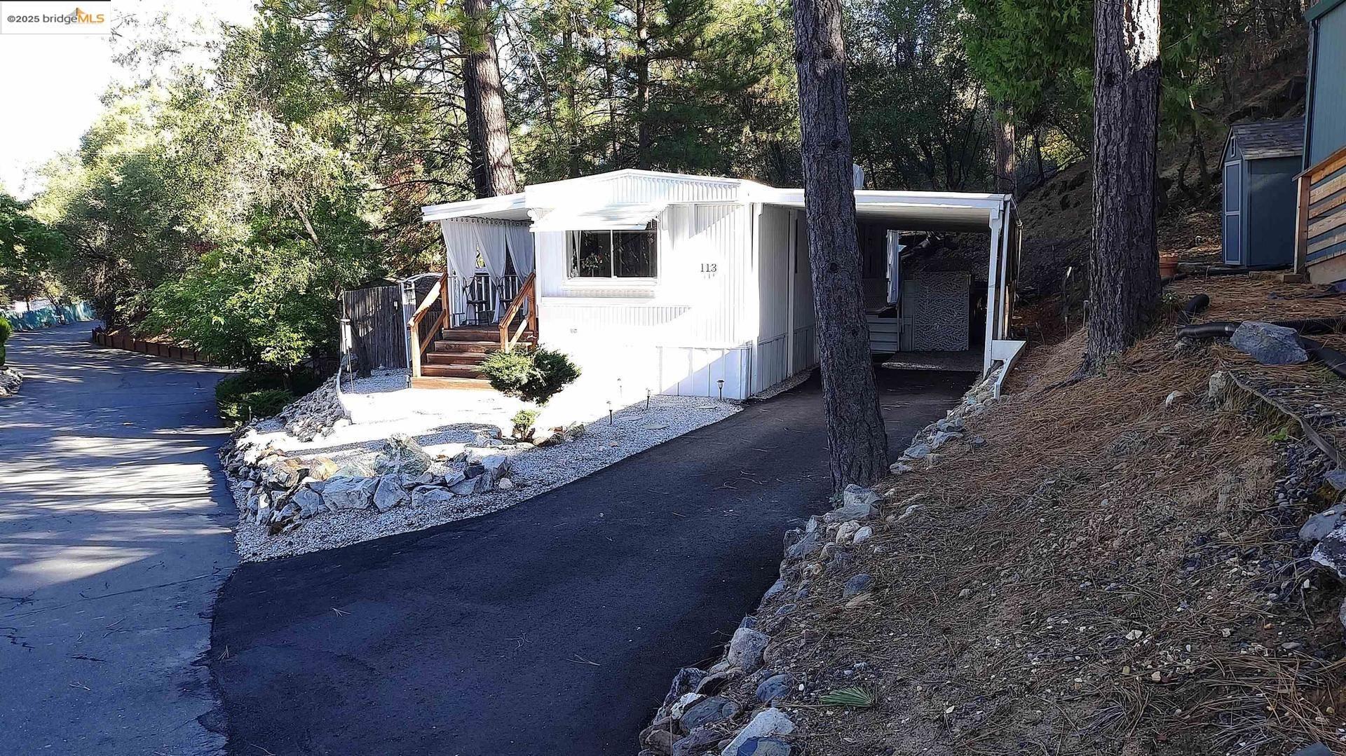 a view of a patio with table and chairs with wooden floor and fence