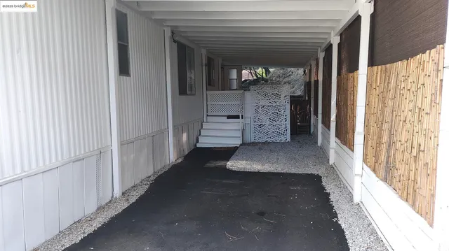 a view of a hallway with wooden walls and entryway
